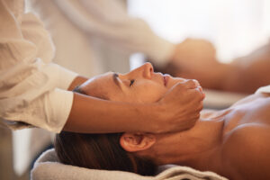 Woman massage with therapist hands, facial and reiki, peace and balance with cosmetic luxury servic.